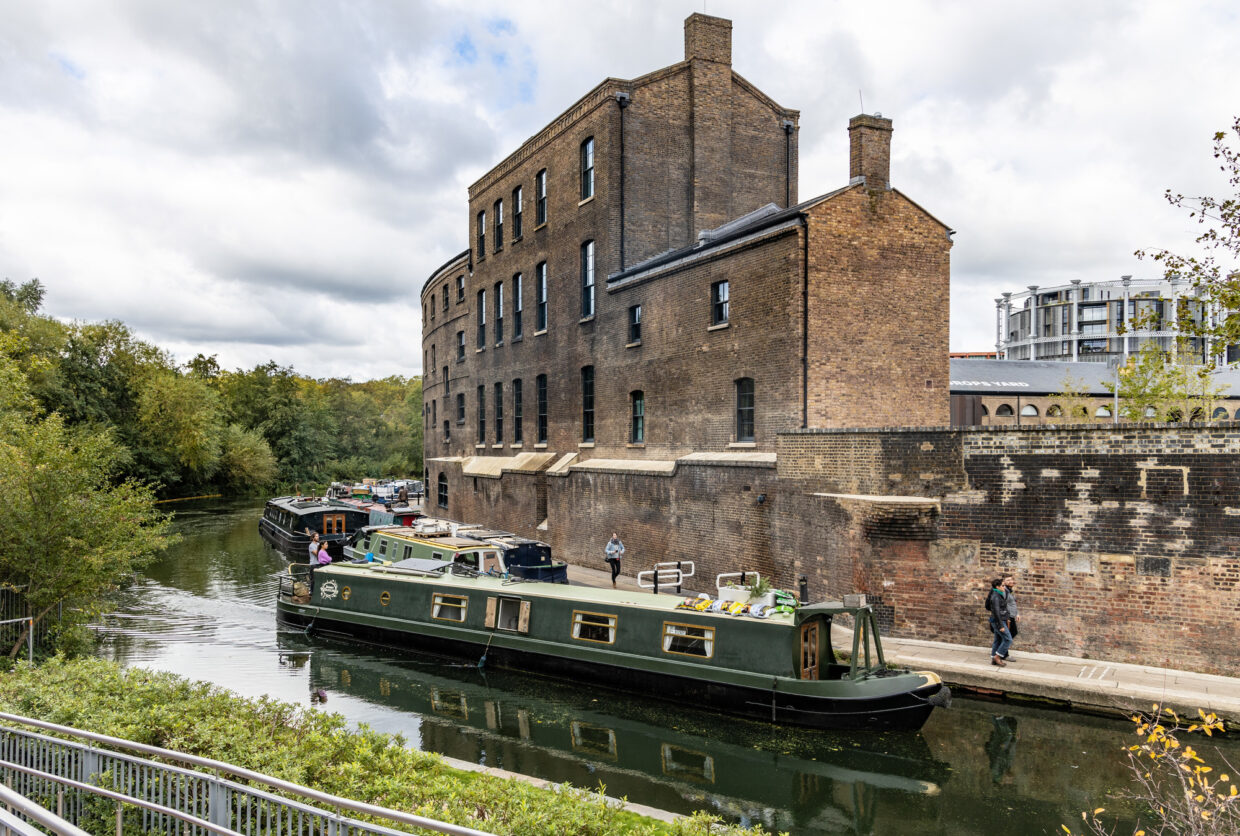 A narrow boat on the Regent's Canal passes the Coal Office at King's Cross